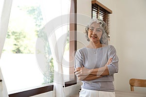 Portrait of smiling senior woman standing posing in home happy confident middle-aged female look at camera show