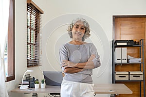 Portrait of smiling senior woman standing posing in home happy confident middle-aged female look at camera show