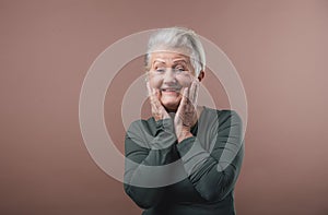 Portrait of smiling senior woman in studio.