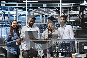 Portrait of smiling server hub engineers using AI algorithms