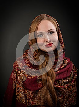 Portrait of smiling slavonic girl with red braided hair