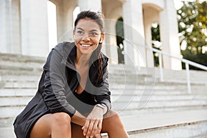 Portrait of a smiling sportsgirl in earphones