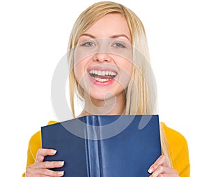 Portrait of smiling student girl with book