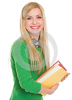 Portrait of smiling student girl with books