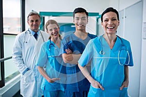 Portrait of smiling surgeons and doctors standing in corridor