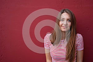 Portrait of a smiling teen girl on a red background