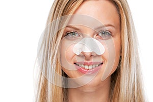 Portrait of smiling teenage girl with clear-up strips on nose