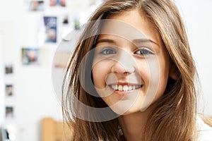 Portrait Of Smiling Teenage Girl At Home