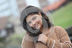 portrait of a smiling teenage girl outdoors