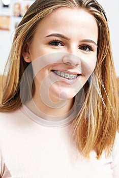 Portrait Of Smiling Teenage Girl Wearing Dental Braces