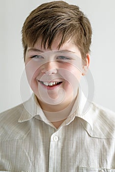 Portrait of smiling teenager boy in a bright shirt photo