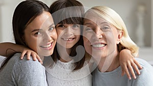 Portrait of smiling three generations of women hugging