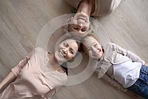 Portrait of smiling three generations of women lying on floor