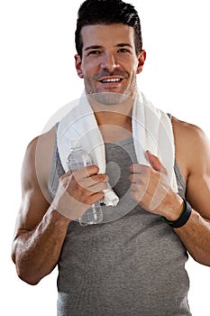 Portrait of smiling tired sportsman with towel and bottle