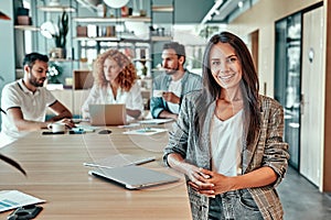 Portrait of smiling top manager standing in office and looking at camera