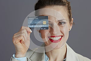 Portrait of smiling trendy female worker in light business suit