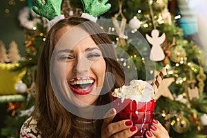 Portrait of smiling trendy woman at modern home