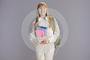 Portrait of smiling trendy young woman in beige tracksuit