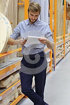 Portrait of a smiling warehouse keeper at work