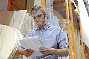 Portrait of a smiling warehouse keeper at work