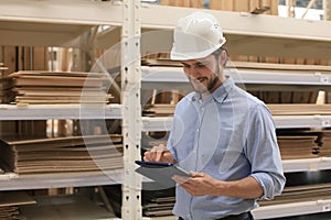 Portrait of a smiling warehouse keeper at work