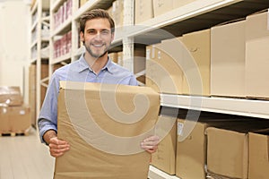 Portrait of a smiling warehouse keeper at work