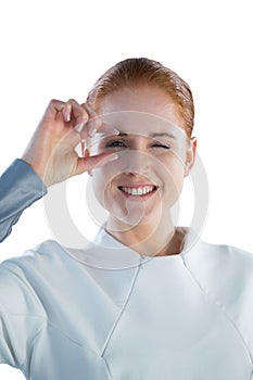 Portrait of smiling woman adjusting imaginary eyeglasses