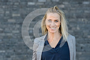 Portrait of smiling woman against grey background