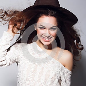 Portrait of smiling woman with beauty long brown hair - posing at studio