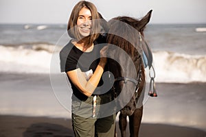 Portrait of smiling woman and brown horse. Young Caucasian woman hugging horse. Romantic concept. Love to animals. Nature concept