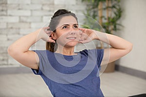 portrait smiling woman doing abdominal crunch