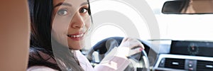 Portrait of smiling woman driver in car salon