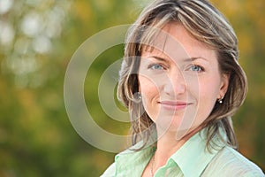 Portrait of smiling woman in early fall park photo