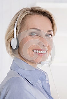 Portrait of smiling woman with headphone on telesales. photo