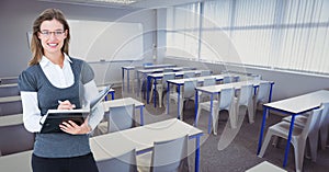 Portrait of smiling woman holding diary in classroom