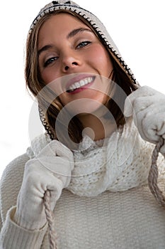 Portrait of smiling woman holding knit hat