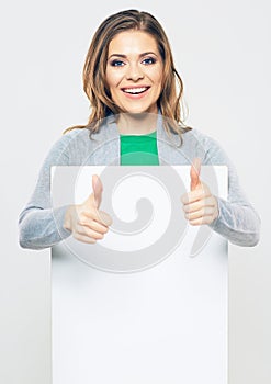 Portrait of smiling woman holding white blank sign board.