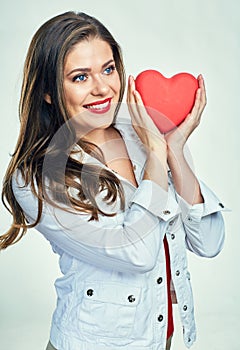 Portrait of smiling woman with long hair holding heart.