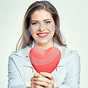 Portrait of smiling woman with long hair holding heart.