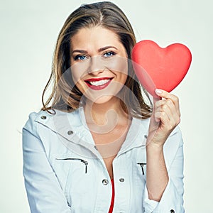 Portrait of smiling woman with long hair holding heart.