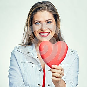 Portrait of smiling woman with long hair holding heart.