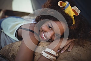 Portrait of smiling woman lying in tent