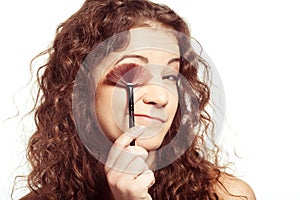 Portrait of smiling woman with make up tools