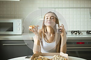 Portrait of a smiling woman with pizza in her hand