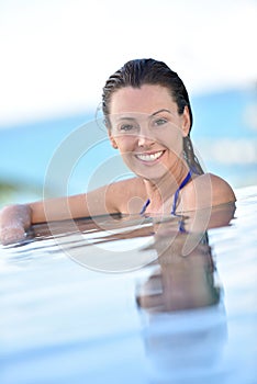 Portrait of smiling woman in the pool