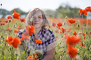 Portrait of smiling woman on poppy field