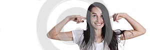 Portrait of smiling woman puts fingers in ears