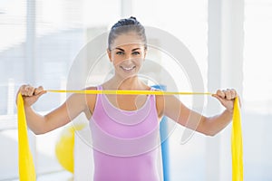 Portrait of smiling woman with resistance band