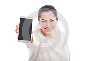 Portrait of smiling woman showing blank smartphone screen