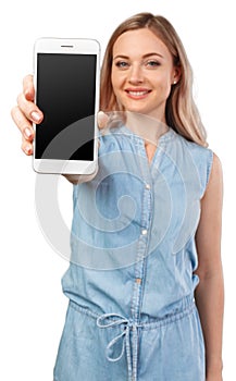 Portrait of a smiling woman showing blank smartphone screen isolated on a white background